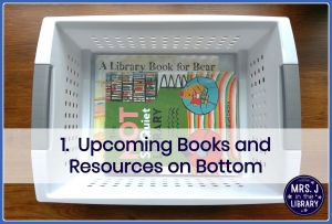 Indigo text overlay reading "1. Upcoming Books and Resources on Bottom" over a photo of a white plastic storage bin with 2 library books in the bottom, sitting on a dark wood background
